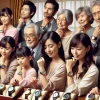 A diverse group of Japanese people from various age groups and backgrounds, looking at luxury watches, showing their wide appeal and popularity across different demographics. The setting is elegant, with no visible brand logos.